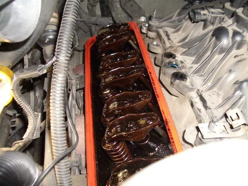 HELP!! lot of gunk under valve covers... is this from coolant?? how to